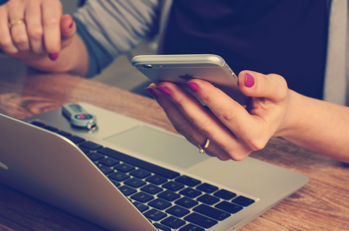 Contact us — phone on desk, ready to connect